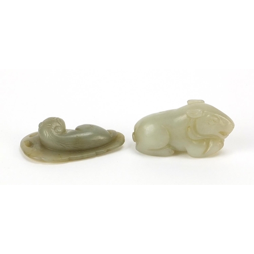 566 - Two Chinese celadon jade carvings including one of a lion on leaf, the largest 5.5cm wide