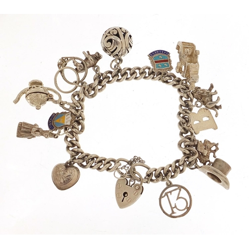 455 - Silver charm bracelet with a selection of mostly silver charms including a top hat, lion, dragon and... 