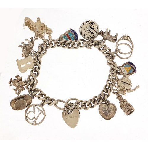 455 - Silver charm bracelet with a selection of mostly silver charms including a top hat, lion, dragon and... 