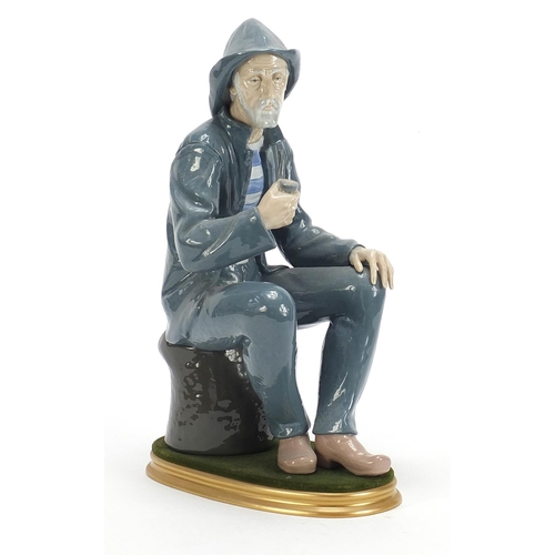 1124 - Large Nao figure of a seated fisherman smoking a pipe, 39cm high