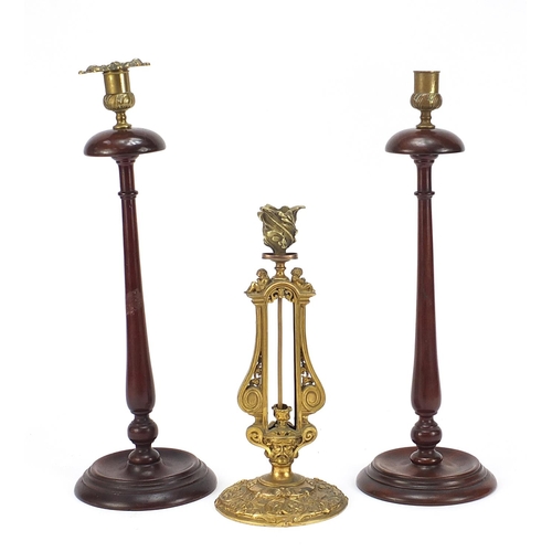 600 - Elkington & Co gilt metal classical candlestick and pair of turned mahogany candlesticks, the Elking... 