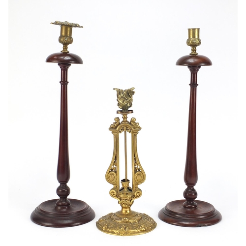 600 - Elkington & Co gilt metal classical candlestick and pair of turned mahogany candlesticks, the Elking... 