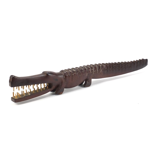 597 - Large African tribal interest carved hardwood alligator with bone teeth, 80cm in length