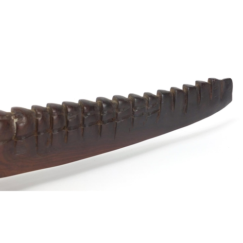 597 - Large African tribal interest carved hardwood alligator with bone teeth, 80cm in length