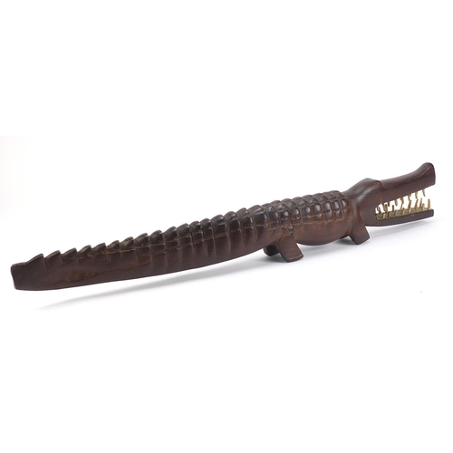 597 - Large African tribal interest carved hardwood alligator with bone teeth, 80cm in length