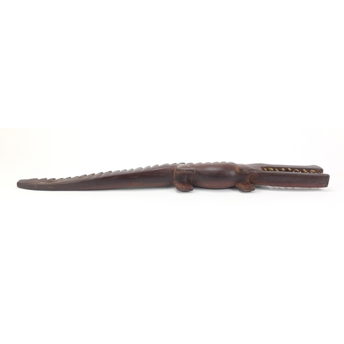 597 - Large African tribal interest carved hardwood alligator with bone teeth, 80cm in length