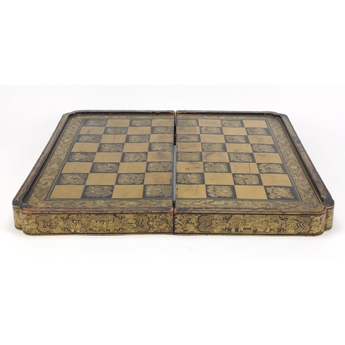 135 - Chinese black lacquered folding chess/games board, finely gilded with figures, flowers and dragons, ... 