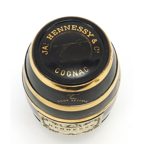 1086 - Bottle of Hennessey cognac housed in a barrel design glass bottle, 19cm high