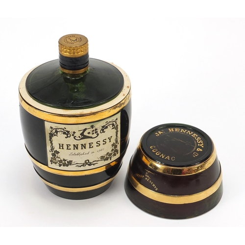 1086 - Bottle of Hennessey cognac housed in a barrel design glass bottle, 19cm high