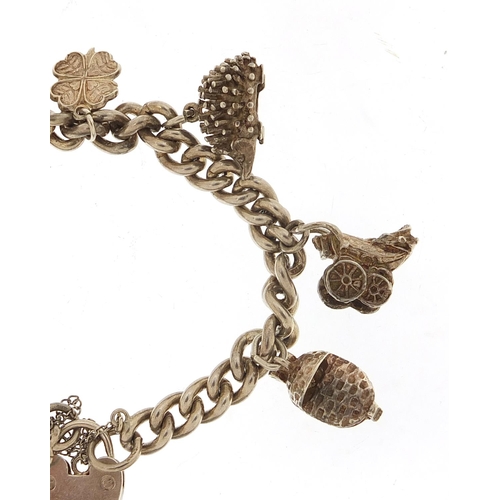 1026 - Silver charm bracelet with a selection of charms including babies' carriage, hedgehog and footballer... 