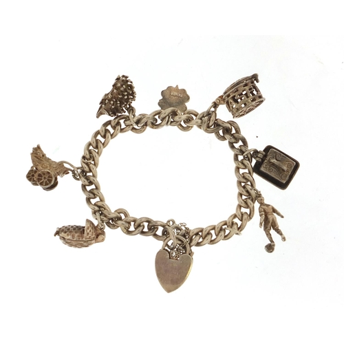 1026 - Silver charm bracelet with a selection of charms including babies' carriage, hedgehog and footballer... 