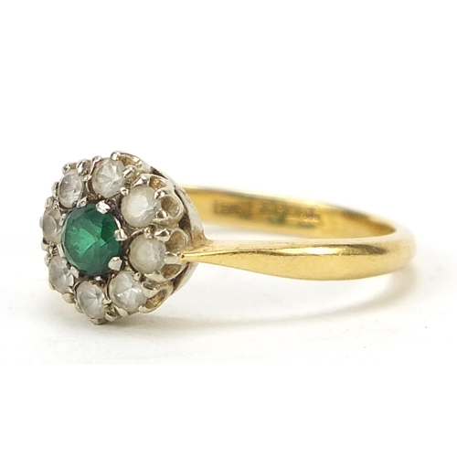 663 - 18ct gold green and clear stone flower head ring, size I/J, 2.6g