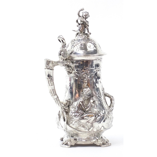 608 - Large classical silver plated stein decorated in relief with a maiden and Putti, 42cm high