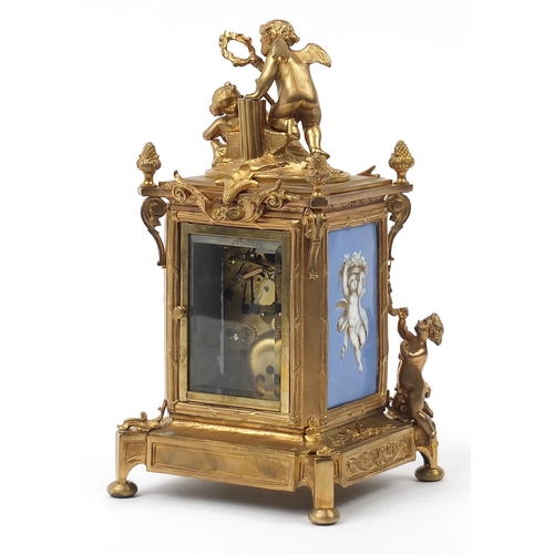 481 - Continental gilt bronze mantle clock with porcelain panels decorated with Putti, 29.5cm high