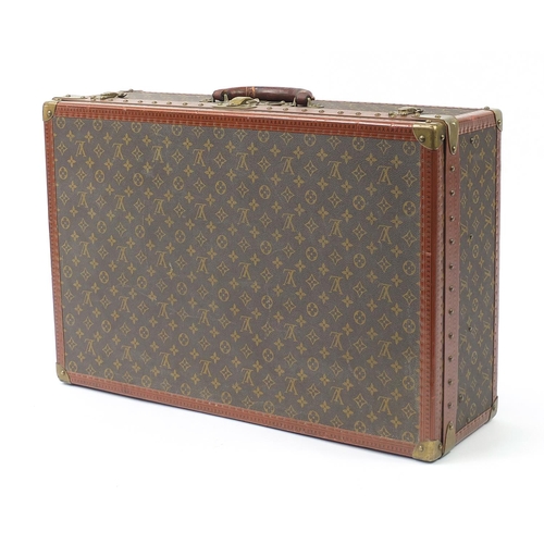 585 - Louis Vuitton, early 20th century suitcase with lift out tray, various impressed marks to the mounts... 