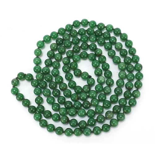 723 - Chinese green jade bead necklace, 66cm in length