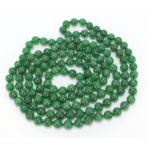 723 - Chinese green jade bead necklace, 66cm in length