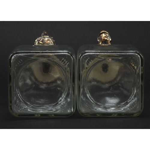 1038 - Pair of glass decanters with rhinoceros and giraffe head stoppers, each 24cm high