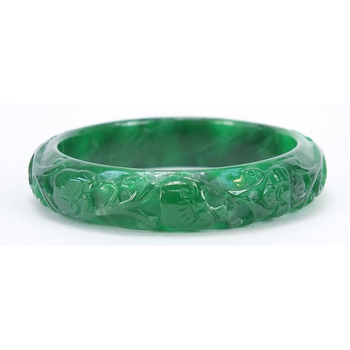 722 - Chinese green jade bangle carved with dragons, 7.5cm in diameter