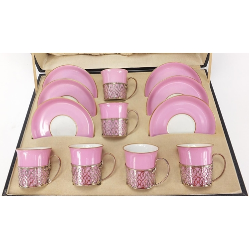 74 - Set of six porcelain coffee cans and saucers with silver cup holders, housed in a velvet and silk li... 