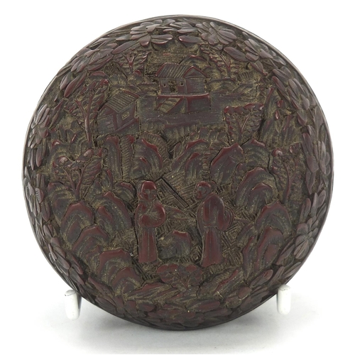 931 - Chinese cinnabar lacquer box and cover carved with two figures in a landscape, 8.5cm in diameter