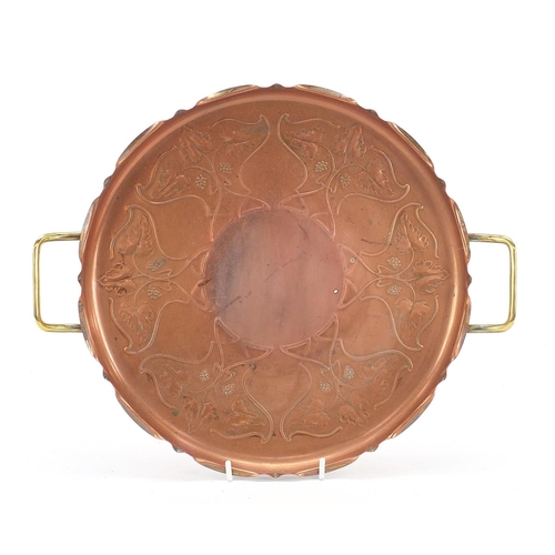 530 - Joseph Sankey & Sons, Arts & Crafts copper and brass three footed tray with twin handles embossed wi... 