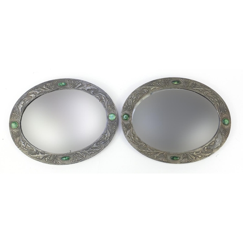 3 - Manner of Liberty & Co, pair of Arts & Crafts oval wall mirrors with embossed pewter mounts and Rusk... 