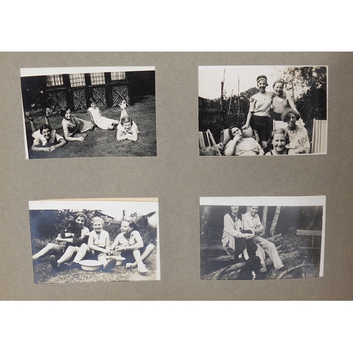 956 - Early 20th century social history photographs arranged in two albums including beach scenes, railway... 