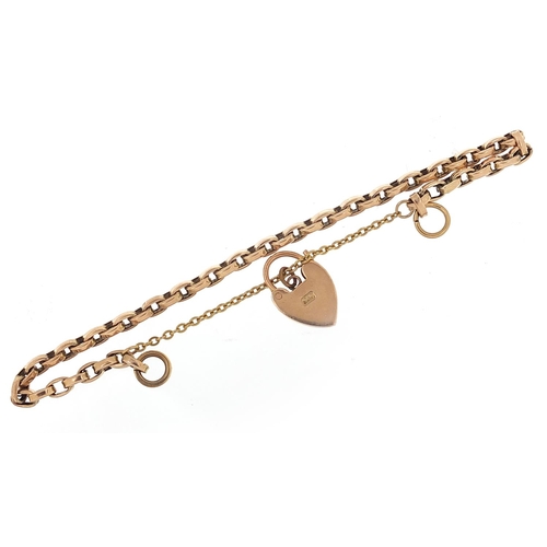 211 - Unmarked gold bracelet, (tests as 9ct gold) with a 9ct gold loveheart padlock, 16cm in length, 7.8g