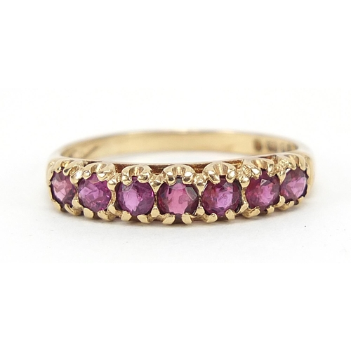 583 - 9ct gold ruby half eternity ring with pierced setting, size P, 2.1g