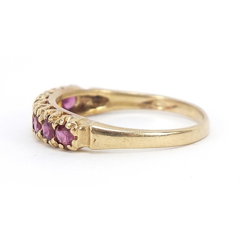 583 - 9ct gold ruby half eternity ring with pierced setting, size P, 2.1g