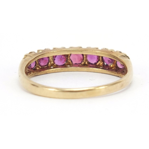 583 - 9ct gold ruby half eternity ring with pierced setting, size P, 2.1g