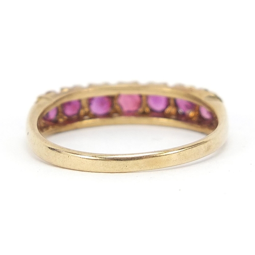 583 - 9ct gold ruby half eternity ring with pierced setting, size P, 2.1g