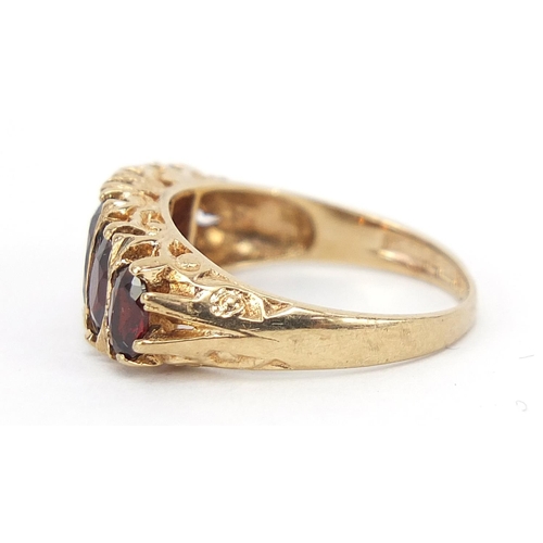 173 - Large 9ct gold graduated garnet five stone ring, size L, 3.2g