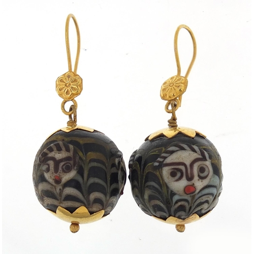 852 - Pair of Islamic unmarked gold mounted glass earrings, hand painted with face masks, 4cm high, 13.0g