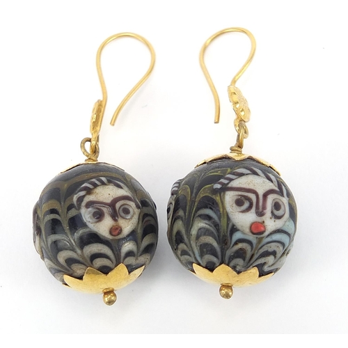 852 - Pair of Islamic unmarked gold mounted glass earrings, hand painted with face masks, 4cm high, 13.0g