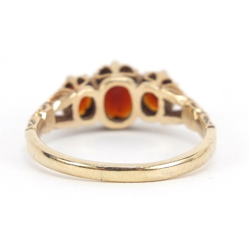 665 - Antique design 9ct gold garnet three stone ring, size Q, 3.0g