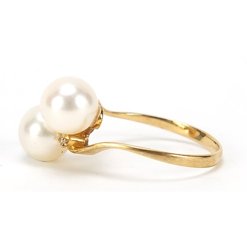 495 - 18ct gold cultured pearl and diamond crossover ring, size L, 2.3g