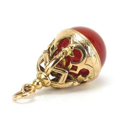 1059 - 9ct gold carnelian orb pendant, 2.5cm high, 7.7g