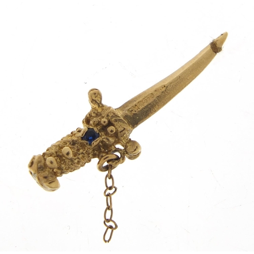 311 - 9ct gold dagger pendant set with blue and green stones, 2.6cm in length, 1.5g