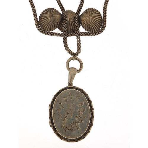 773 - Large Victorian unmarked silver locket on a shell design necklace, 5cm high and 38cm in length, tota... 