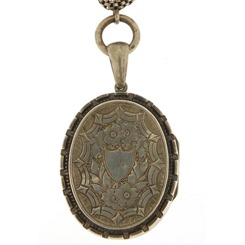 773 - Large Victorian unmarked silver locket on a shell design necklace, 5cm high and 38cm in length, tota... 