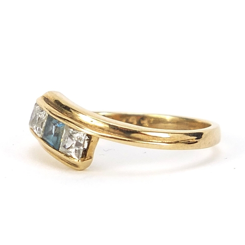 313 - 9ct gold blue stone and cubic zirconia crossover ring, size K, 1.7g