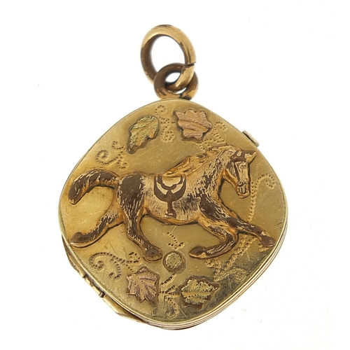 986 - Gold coloured metal galloping horse locket, 2.2cm high, 4.5g