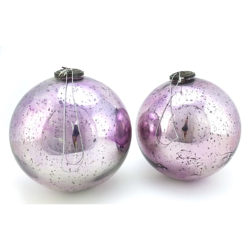 334 - Two large Victorian mirrored mauve glass witches balls, the largest 25cm in diameter