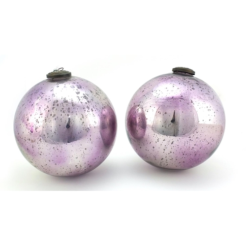 334 - Two large Victorian mirrored mauve glass witches balls, the largest 25cm in diameter