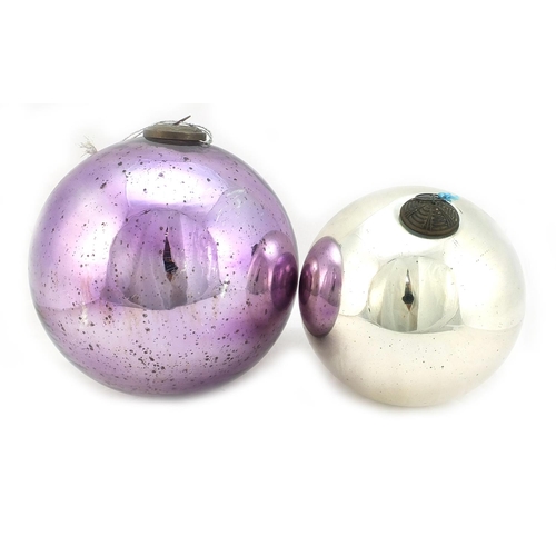 333 - Two large Victorian mirrored glass witches balls including a mauve example, the largest approximatel... 