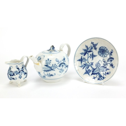 869 - Meissen Blue Onion pattern comprising teapot, three footed cream jug and saucer, the largest 17cm in... 