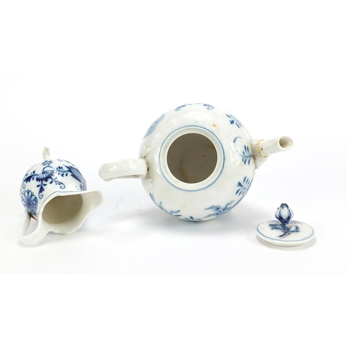 869 - Meissen Blue Onion pattern comprising teapot, three footed cream jug and saucer, the largest 17cm in... 