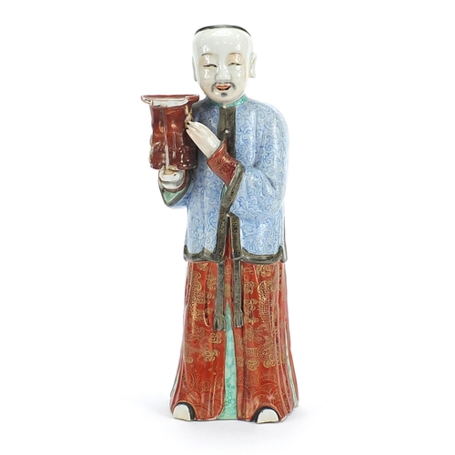 718 - Chinese porcelain figural candlestick of a robed gentleman hand painted in the famille rose palette,... 